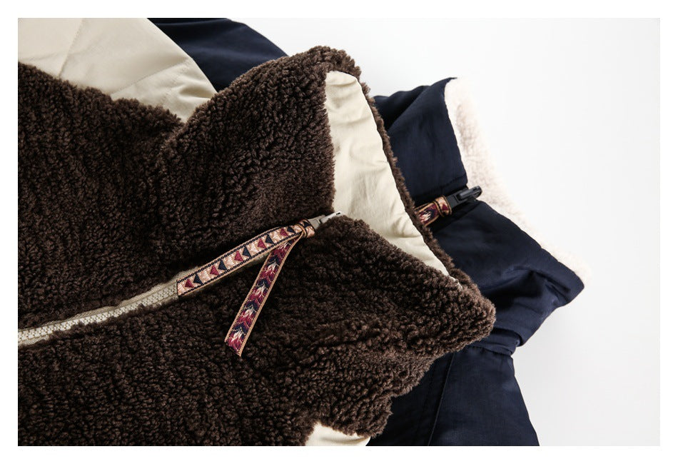 Close-up of cream and navy jackets showing brown fleece lining and patterned zipper trim.