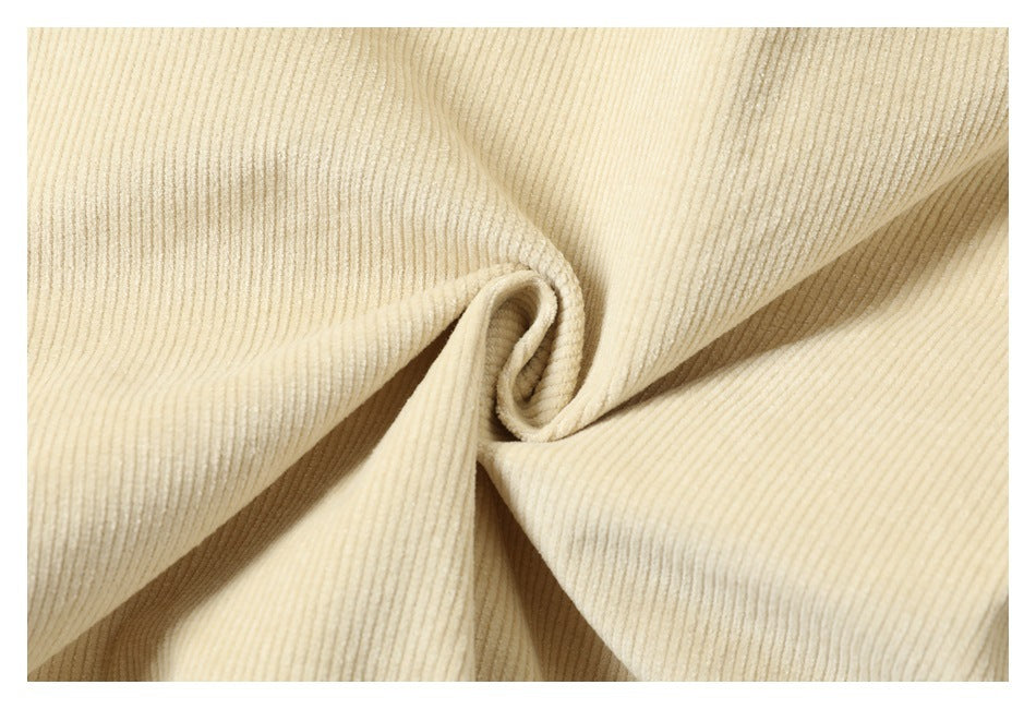Close-up of cream-colored ribbed fabric gathered into a central twist.
