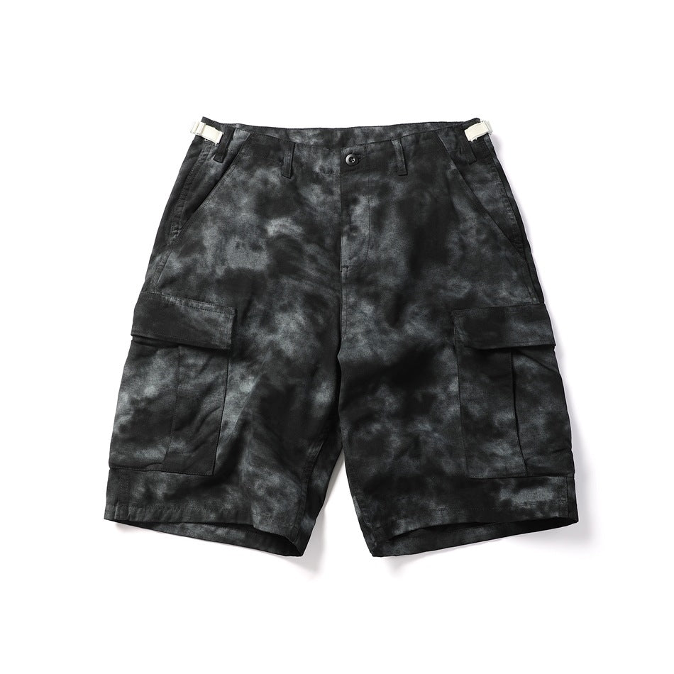 Black tie-dye cargo shorts, flat lay front view with flap thigh pockets and side buckle tabs