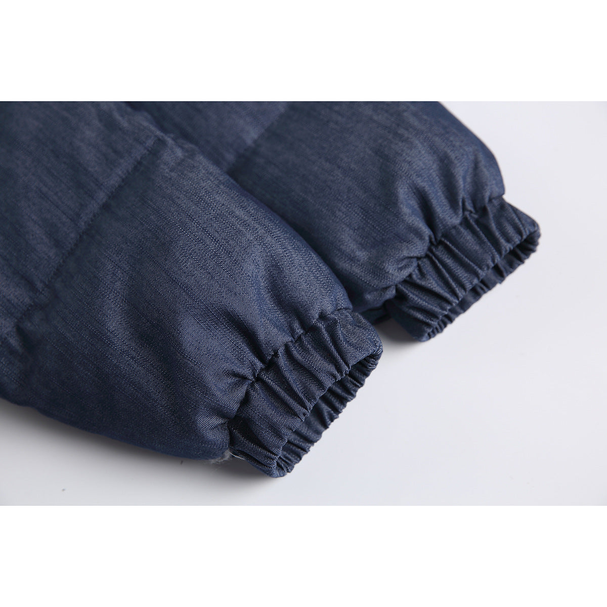 Close-up of the navy jacket's gathered elastic sleeve cuffs.