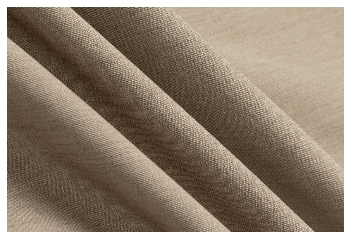 Close-up of beige fabric in soft folds, showing its fine woven texture.