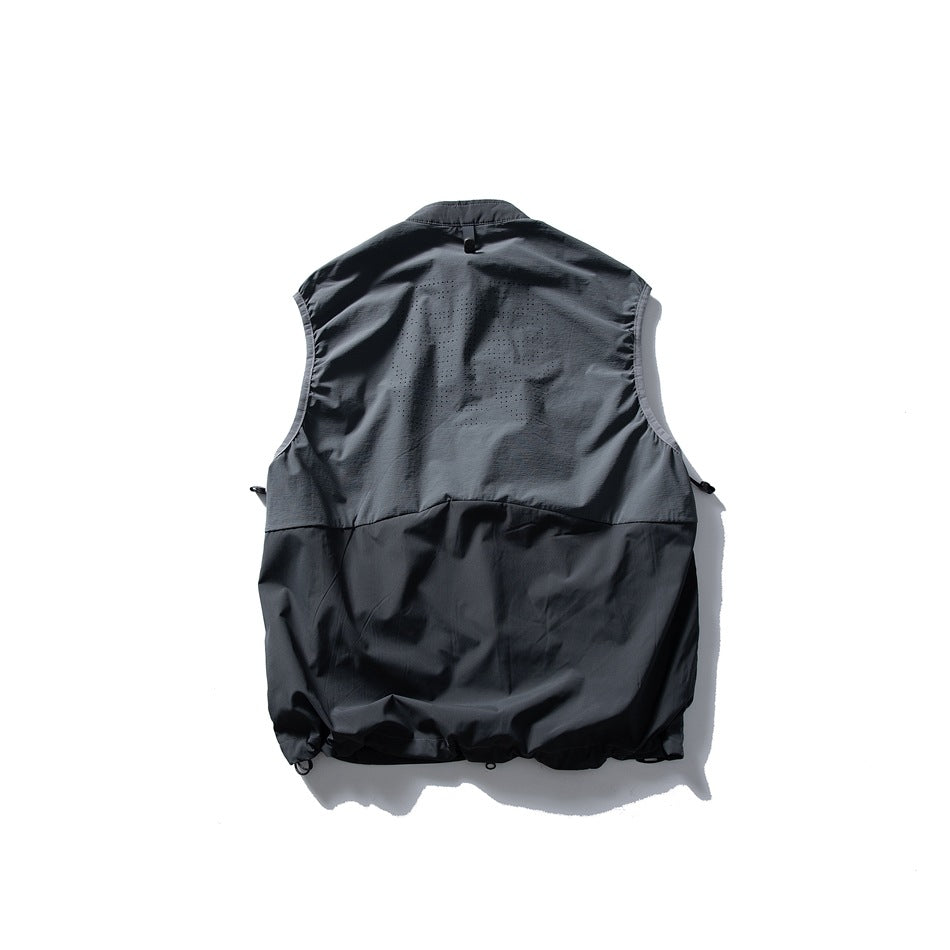 Back of a black sleeveless vest with a perforated upper panel and adjustable hem, shown against white.