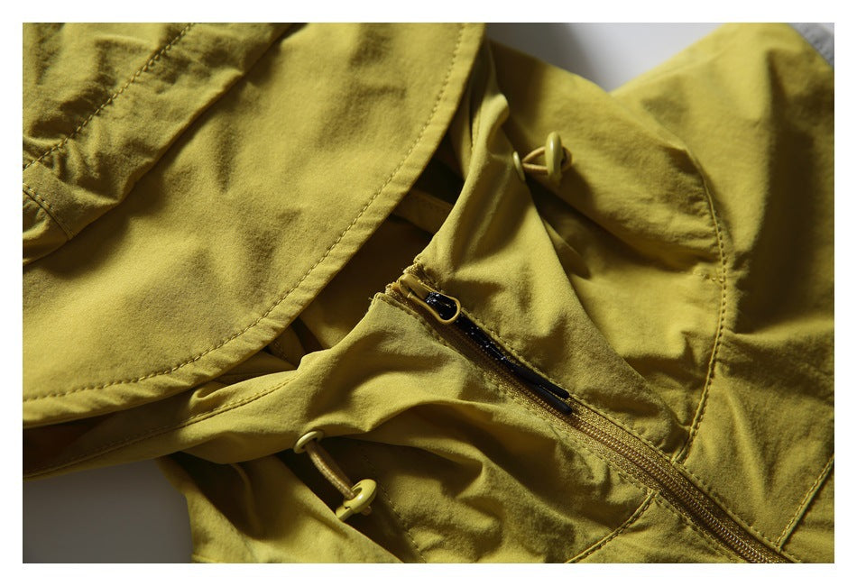 Close-up of the vest's hood and upper front, with drawcord toggles and a short zipper.