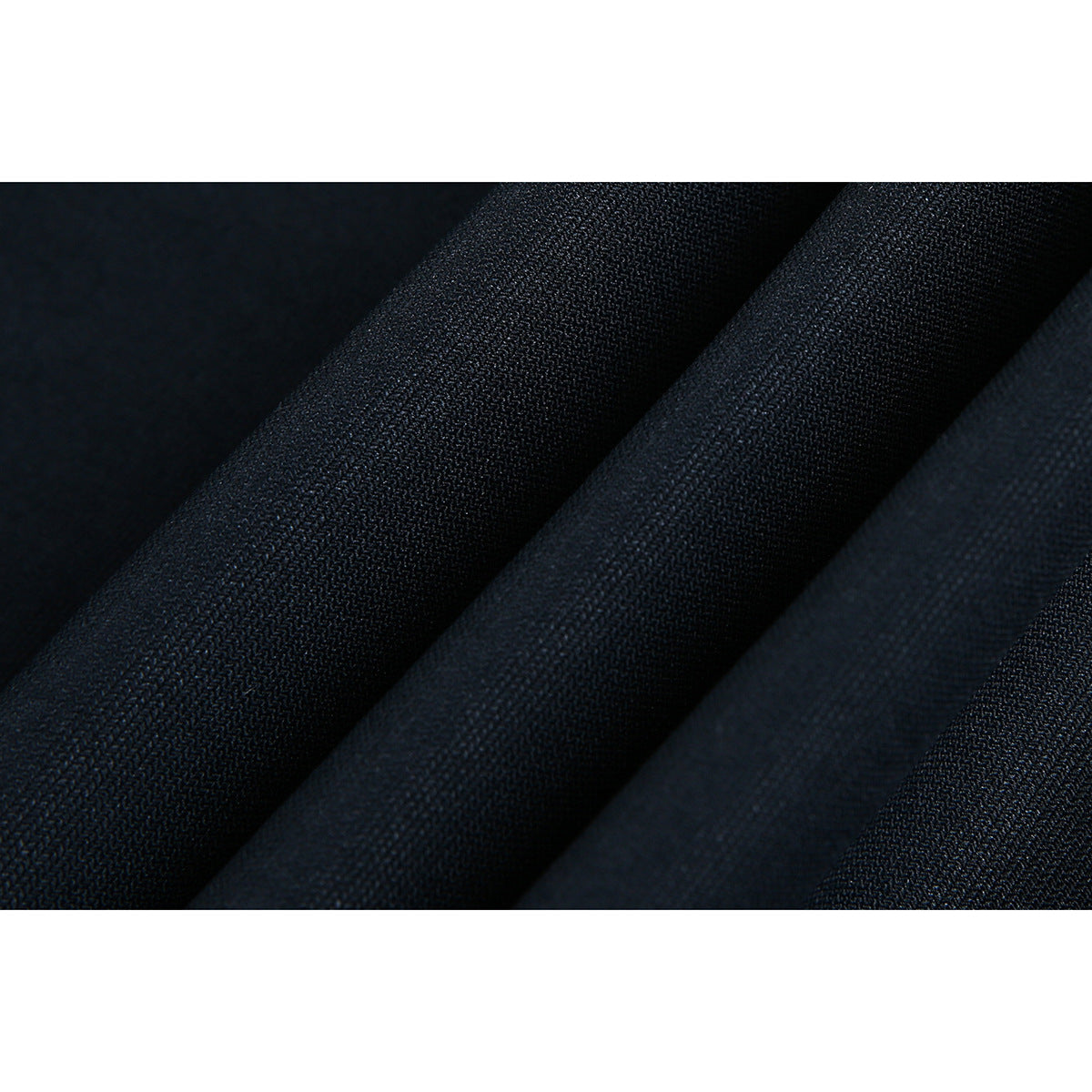 Extreme close-up of the dark navy shirt surface and its visible weave.