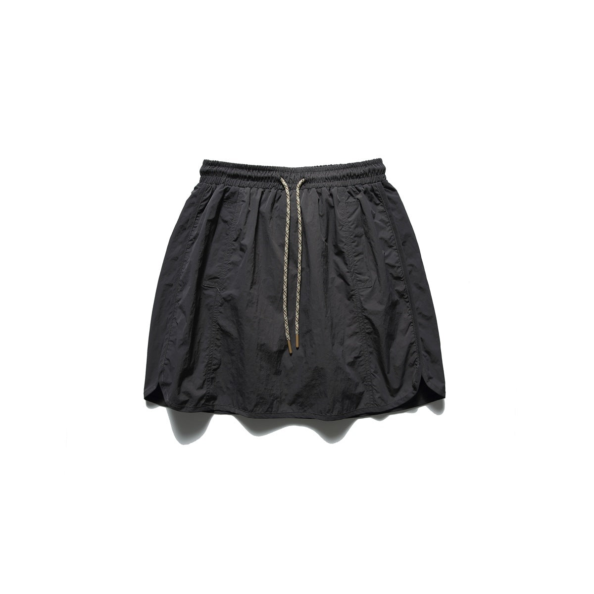 Dark gray drawstring mini skort laid flat, front view, with crinkled fabric and curved side hems