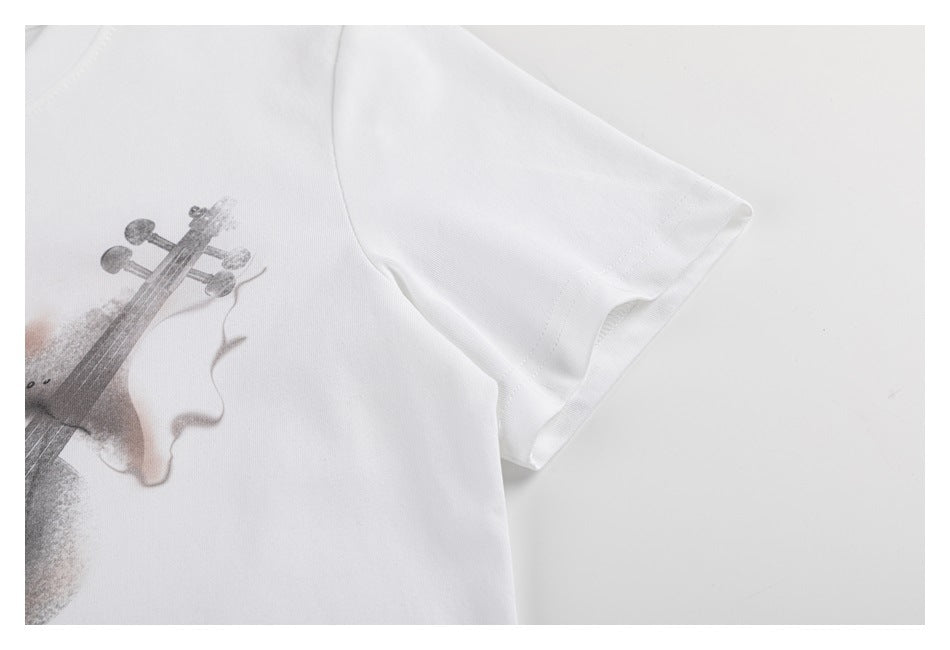 Close-up of a white T-shirt sleeve and partial gray violin print.