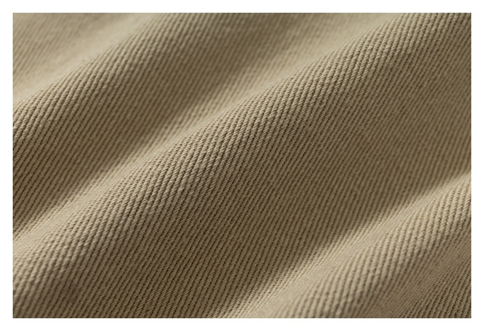 Extreme close-up of diagonally ribbed tan-brown fabric folds.