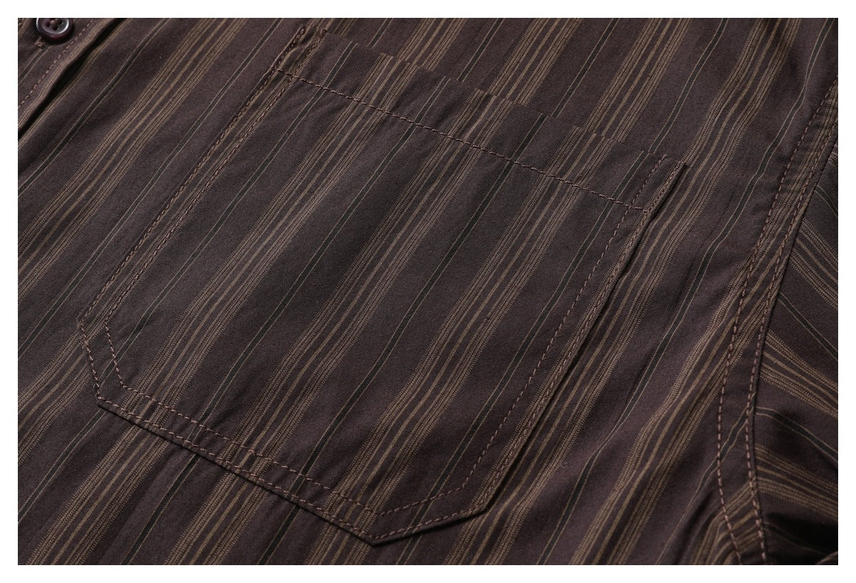Close-up of a chest pocket on a dark brown shirt with narrow tan stripes.