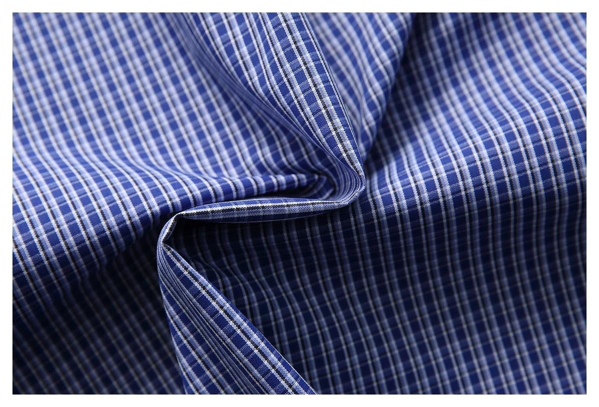Close-up of blue-and-white checked shirt fabric draped in soft folds.