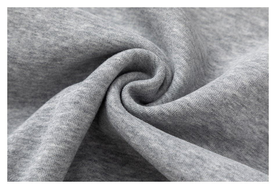 Macro view of heather-gray sweatshirt fabric gathered into a soft fold.