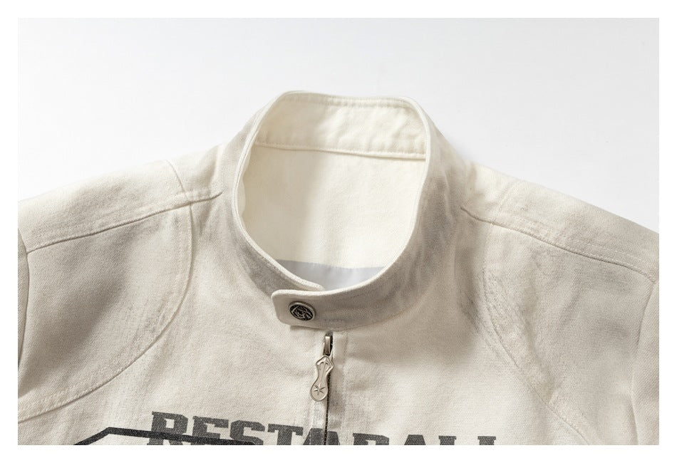 Close-up of the jacket's off-white stand collar, snap fastening, zipper and partially visible dark front graphic.