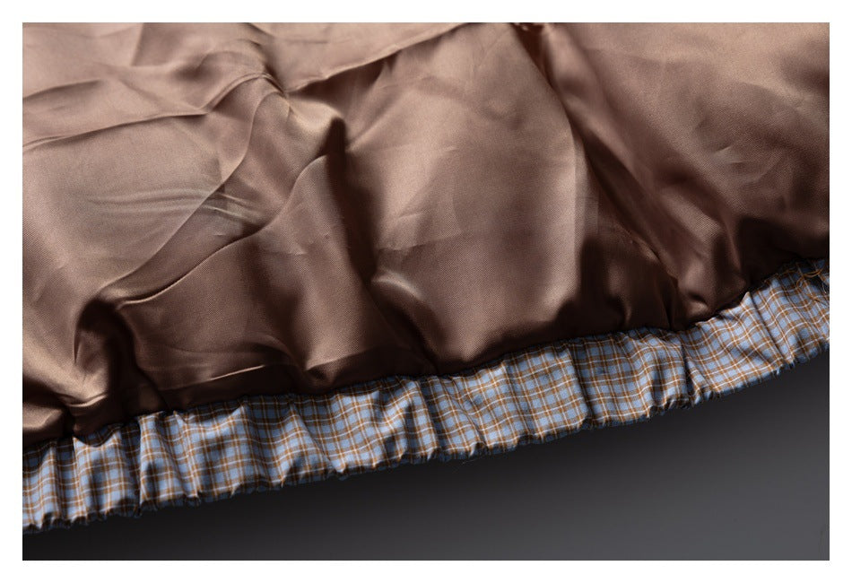 Close-up of the jacket's smooth brown lining and checked gathered edge.