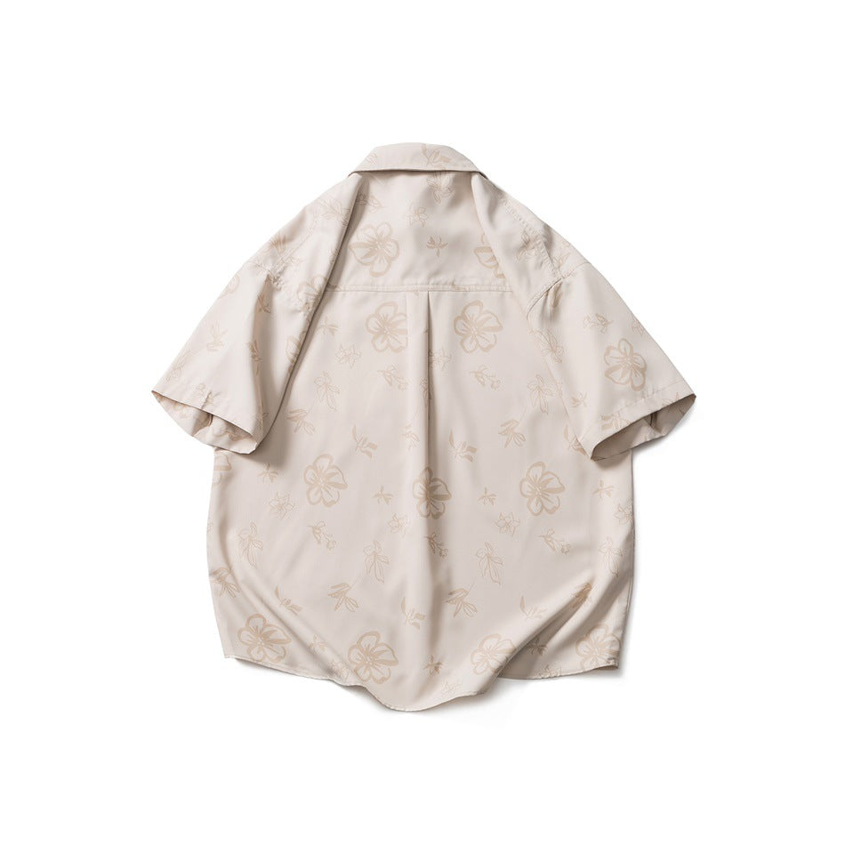 Back view of khaki short-sleeve shirt with tonal floral print, back yoke and center pleat, flat lay