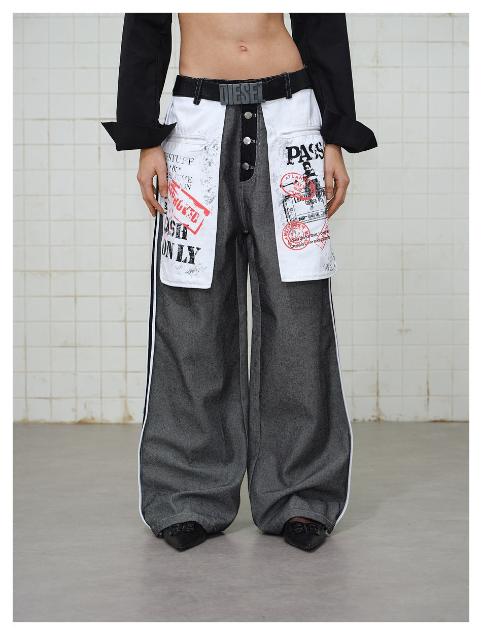 Model wearing wide-leg gray jeans with exposed button fly and white printed front pocket panels, front view