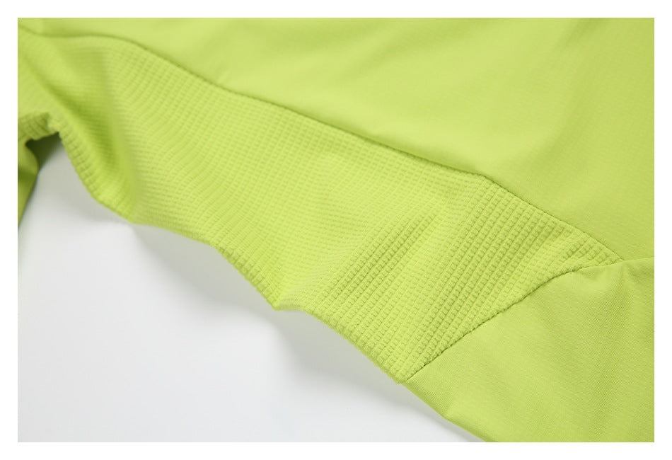 Close-up of a lime-green garment showing a textured panel between smooth fabric sections.