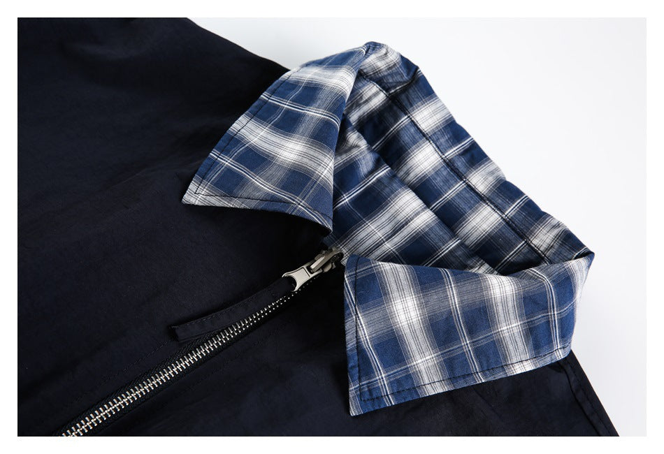Close-up of the navy jacket's blue plaid collar and silver zipper.