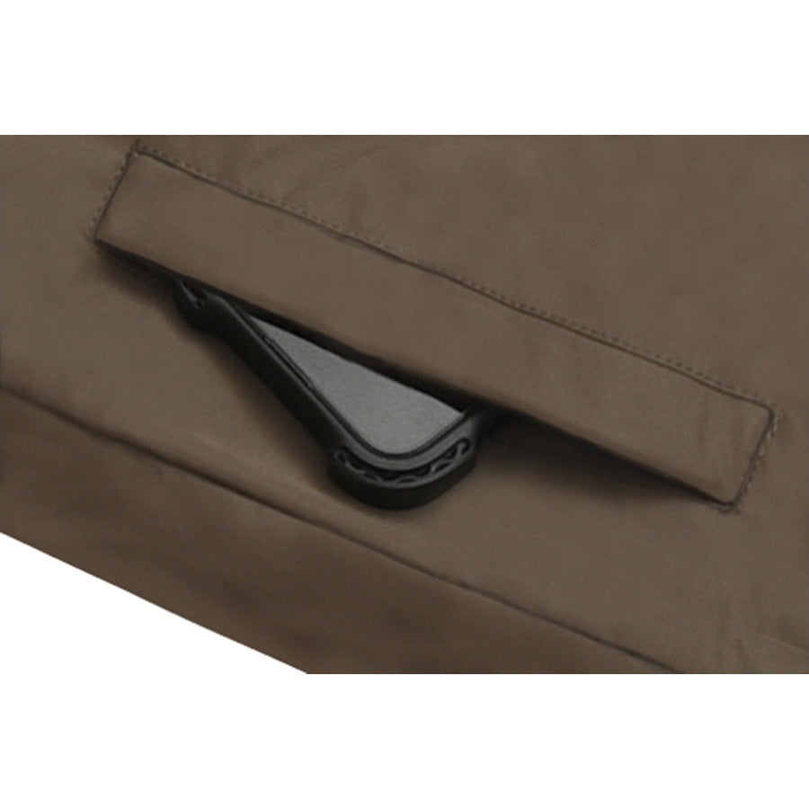 Close-up of a brown jacket pocket flap with a dark fastening beneath it.