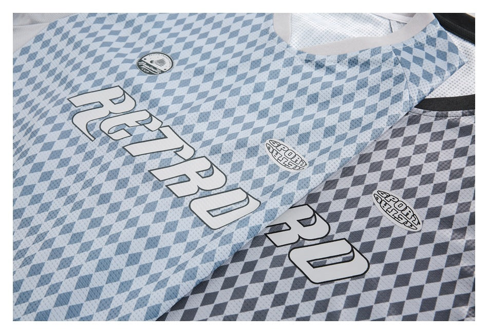Close-up of two blue and gray diamond-patterned jerseys with large white lettering and oval chest emblems.