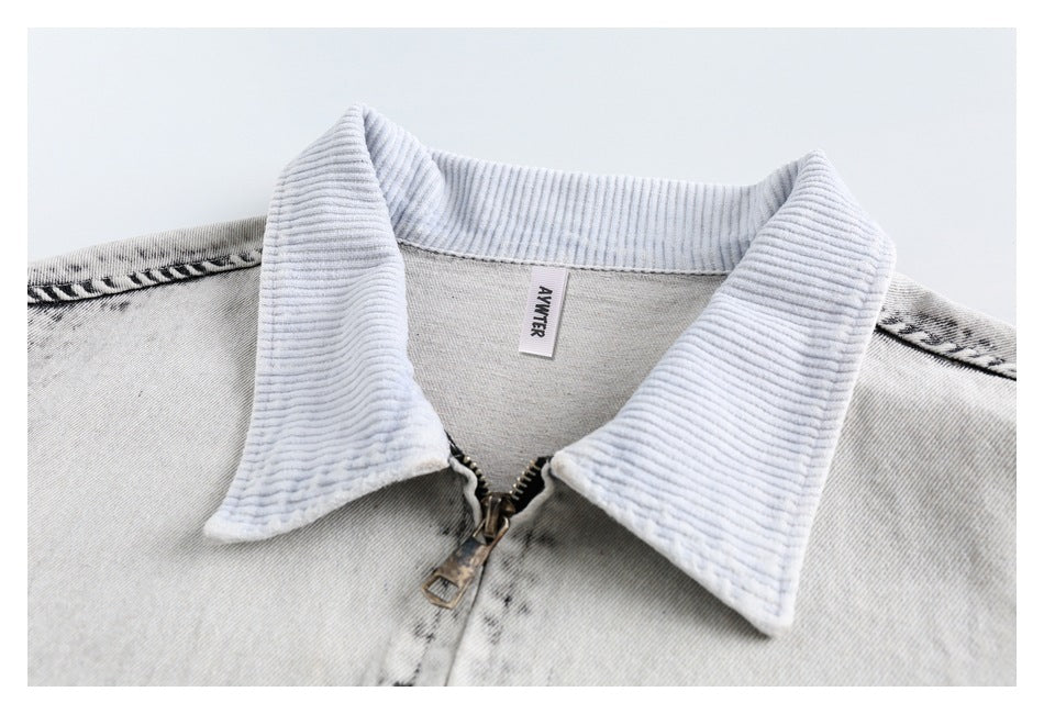 Close-up of the jacket's pale ribbed collar, front zipper, and small interior neck label.