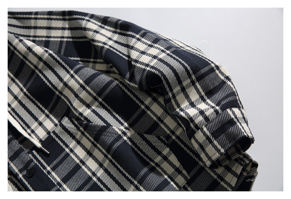 Close-up of the plaid sleeve and shoulder, showing the buttoned cuff detail.
