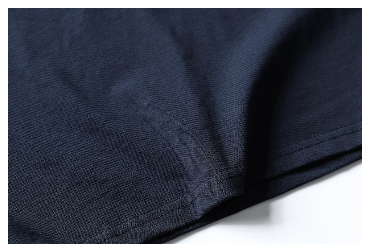 Close-up of the dark navy shirt's bottom hem with parallel rows of stitching.