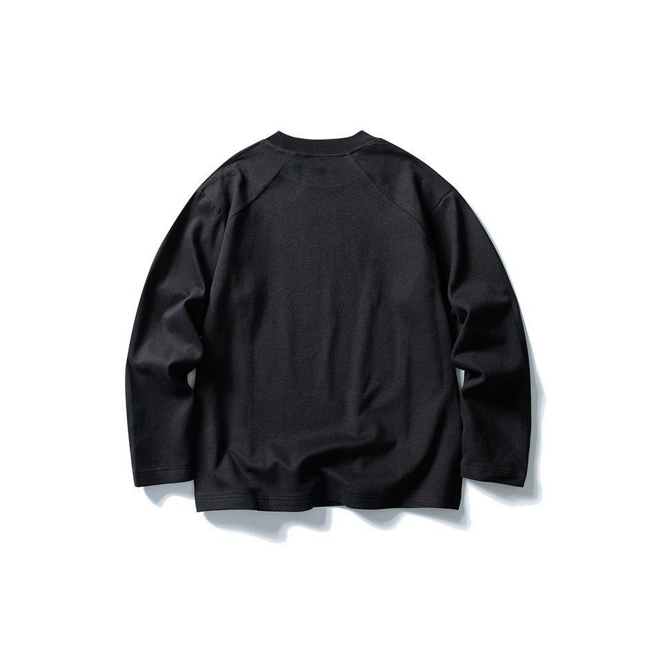 Back view of a black long-sleeve crew neck top with raglan sleeves on a white background