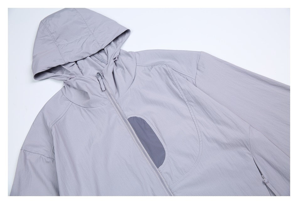 Angled close view of a light gray hooded jacket showing its front zipper and curved blue-gray chest detail.