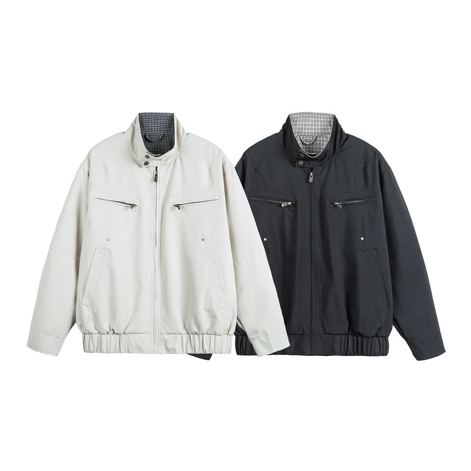 Two front-facing jackets, one off-white and one charcoal, with checked collars and zip pockets.