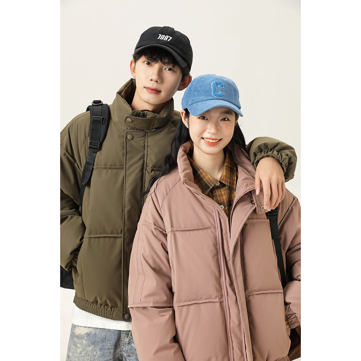 Two models pose close up in an olive jacket and a dusty rose jacket with high collars and front pockets.
