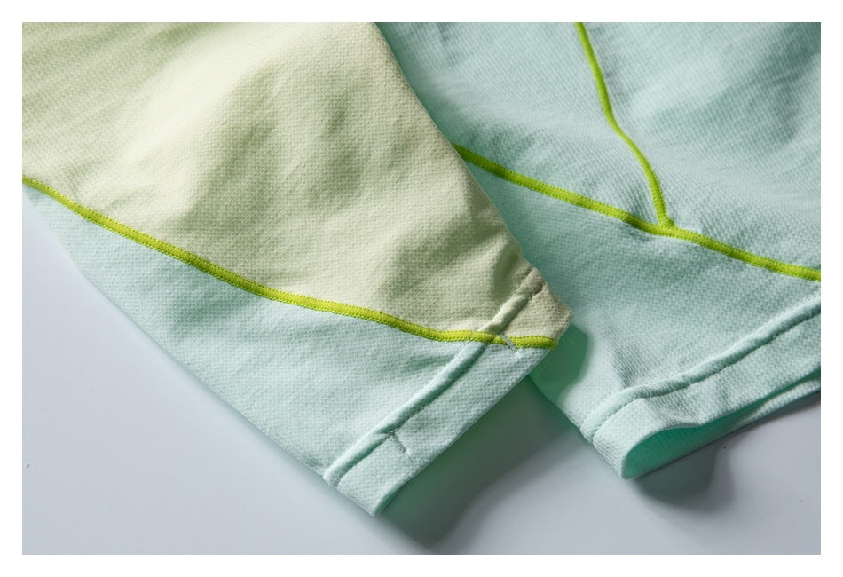 Close-up of the mint and pale yellow top showing a sleeve cuff and lime contrast seam.
