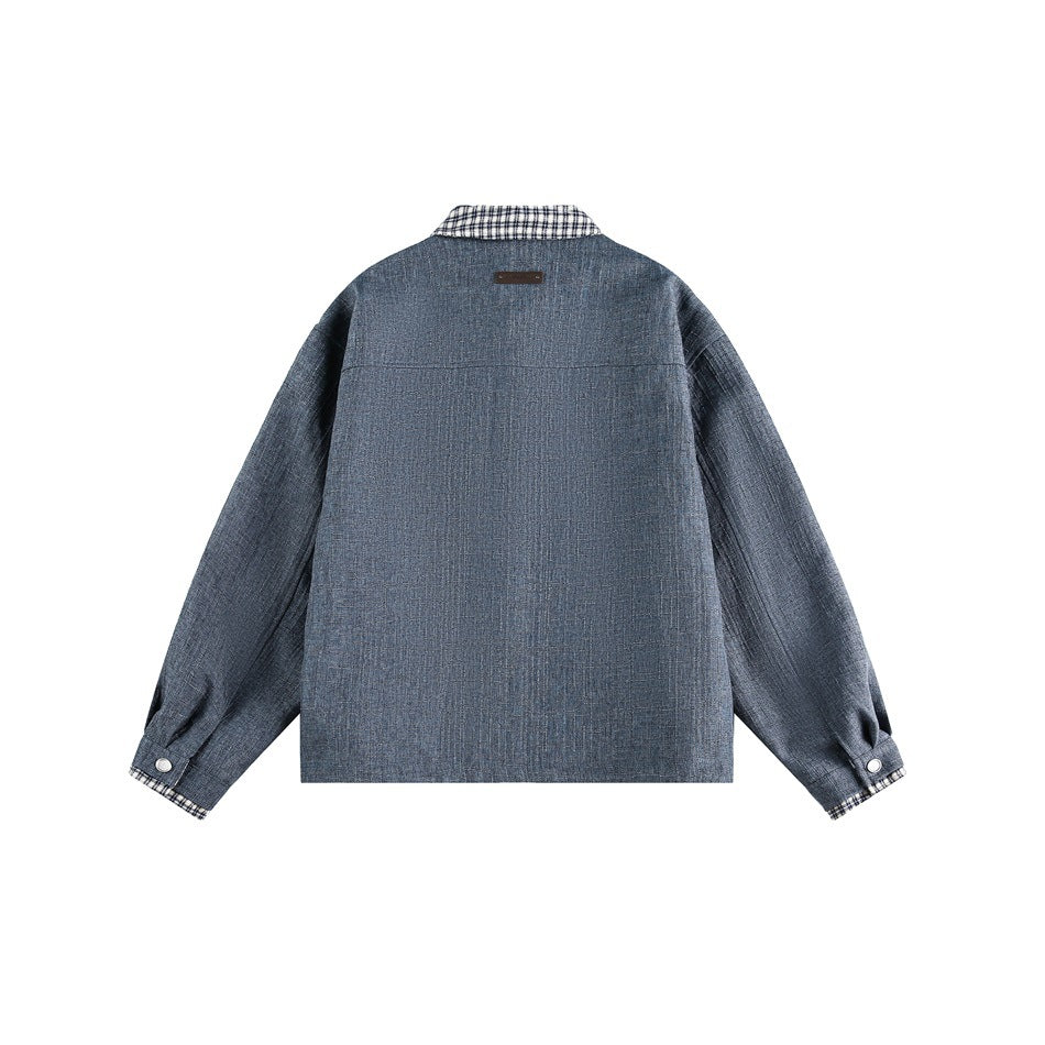 Back view of a blue-gray jacket with a plaid collar and plaid trim at the cuffs.