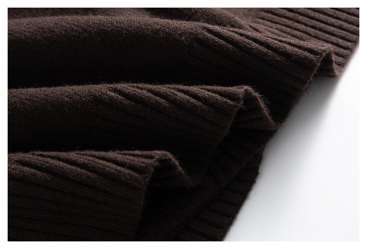 Close-up of dark brown ribbed knit fabric with folded edges.