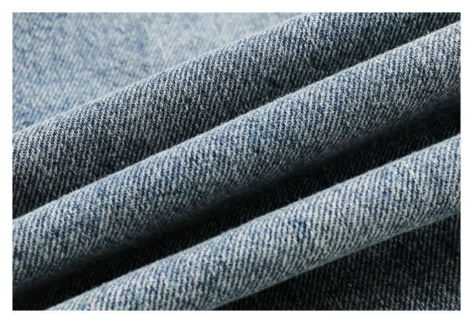Macro view of the blue-and-white woven texture of denim fabric.