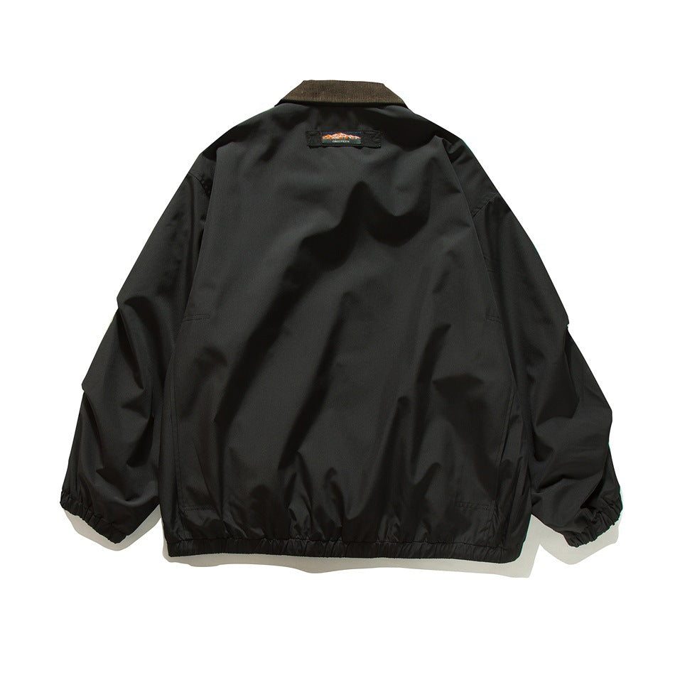 Back view of a black jacket with a dark brown collar, gathered cuffs and hem, and a small upper-back label.