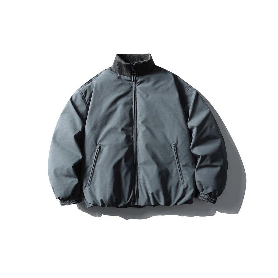 Gray stand-collar zip-up puffer jacket with ribbed collar, zippered pockets and elastic cuffs, front flat lay