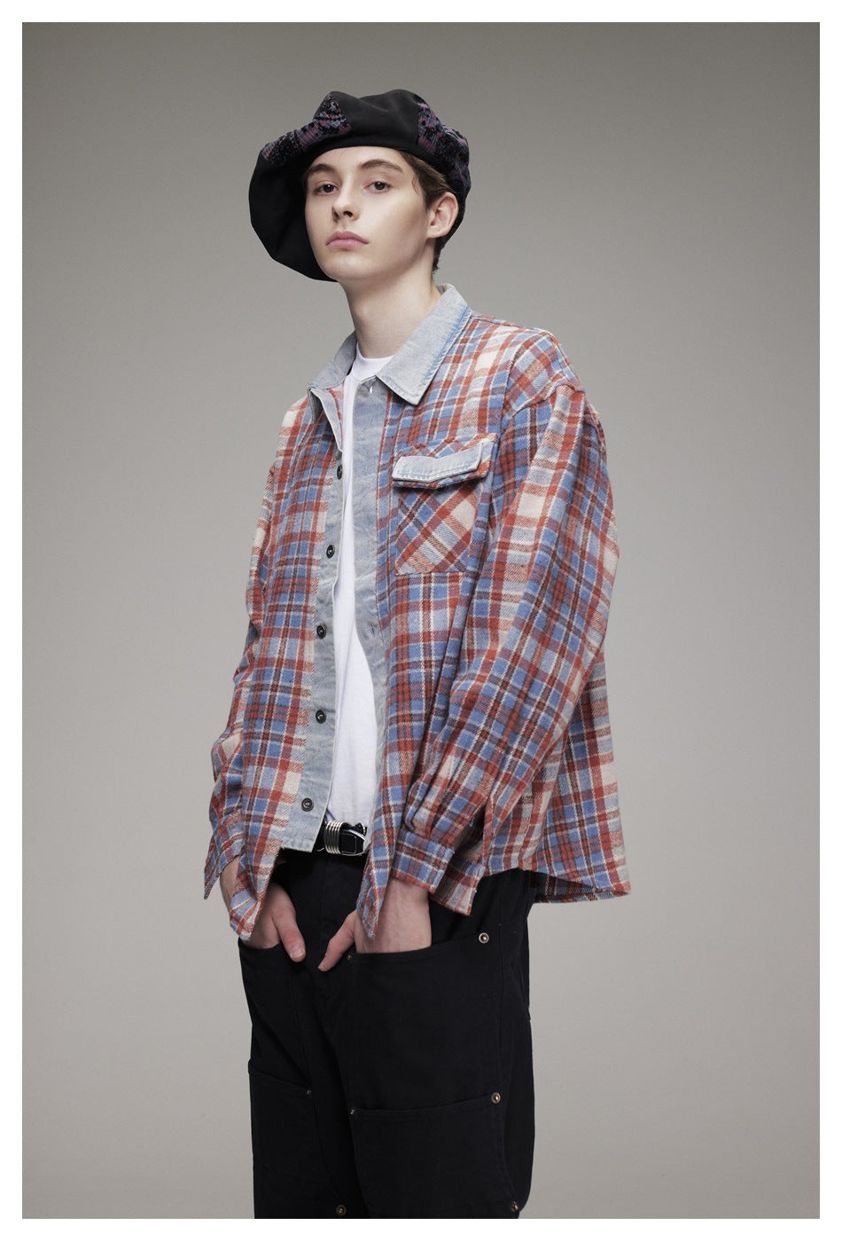 Model wearing the open plaid shirt with denim-look trim over a white tee, black pants and a patterned beret