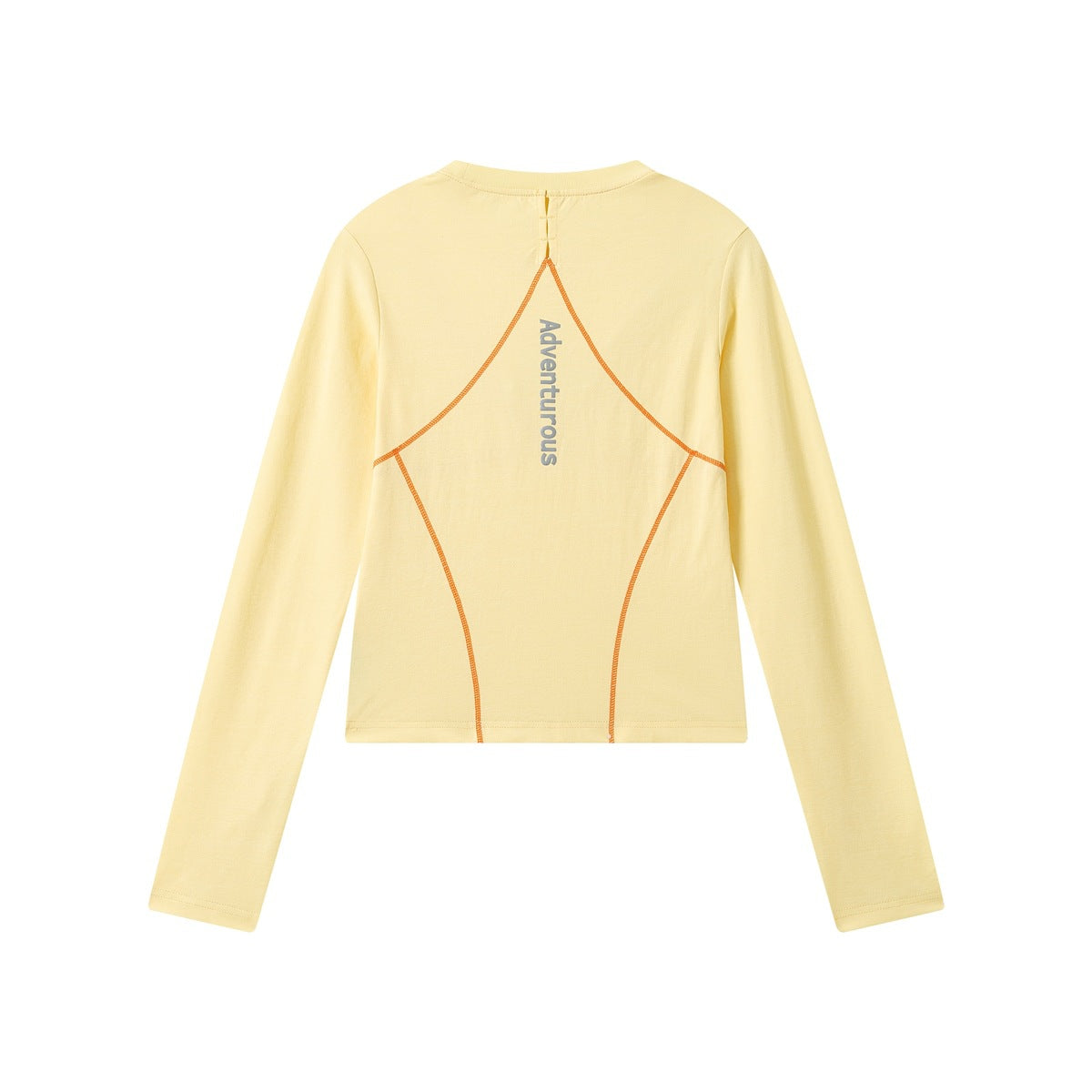 Back view of a pale yellow long-sleeve cropped top with orange curved seams and vertical “Adventurous” lettering.