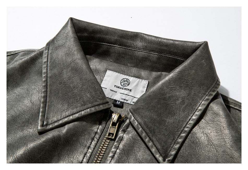 Close-up of a charcoal gray textured jacket collar, zipper, and sewn-in label.