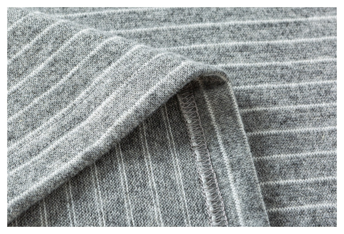 Close-up of the gray-and-white striped shirt's folded hem and overlocked seam.