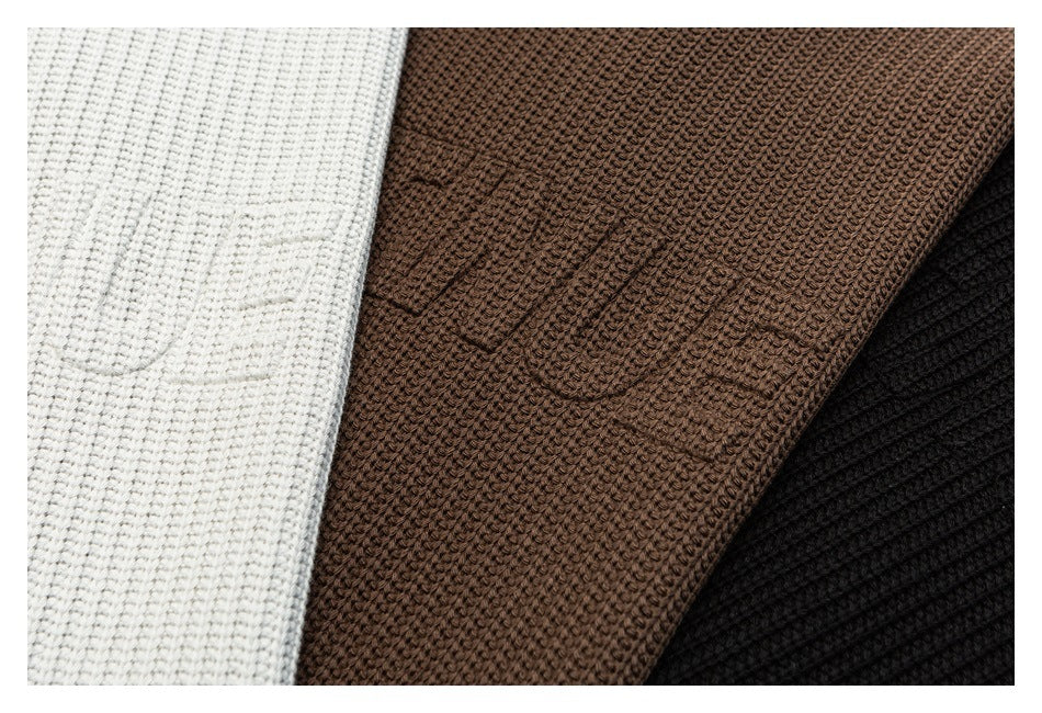 Close-up of textured knit fabric in ivory, brown, and black colorways.