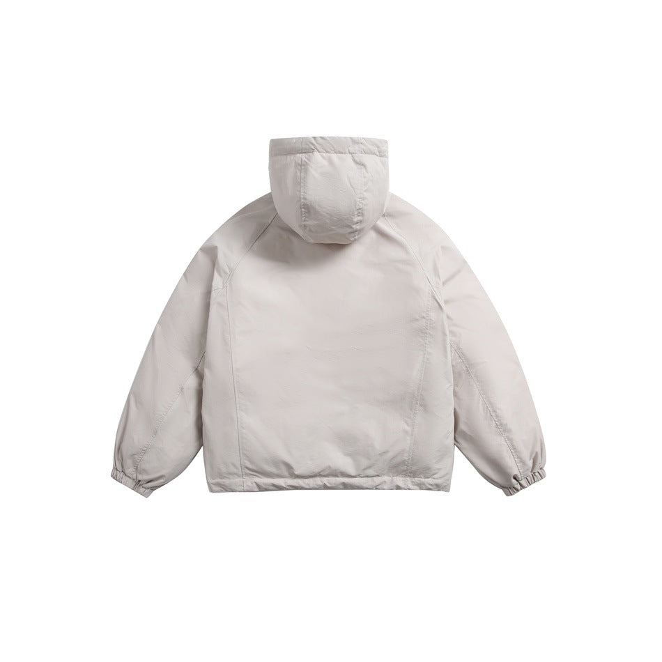 Back view of a light beige hooded jacket with long sleeves and elastic cuffs.