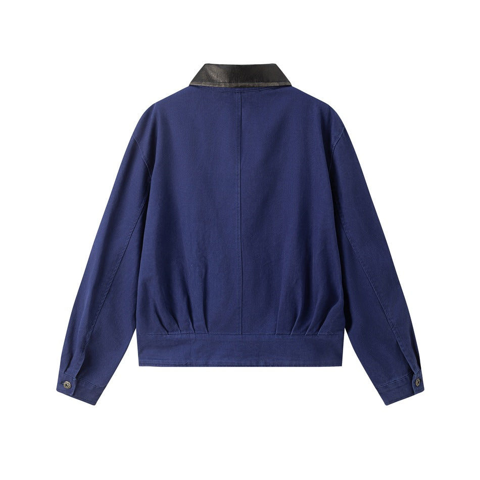 Back view of a blue jacket with a black collar, center seam, and buttoned cuffs.