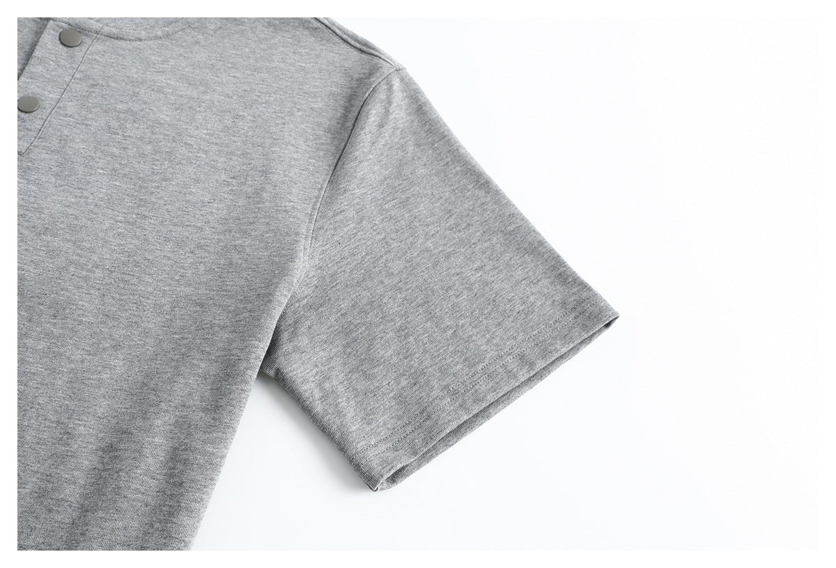 Close-up of the heather gray shirt's short sleeve and shoulder seam against a white background.
