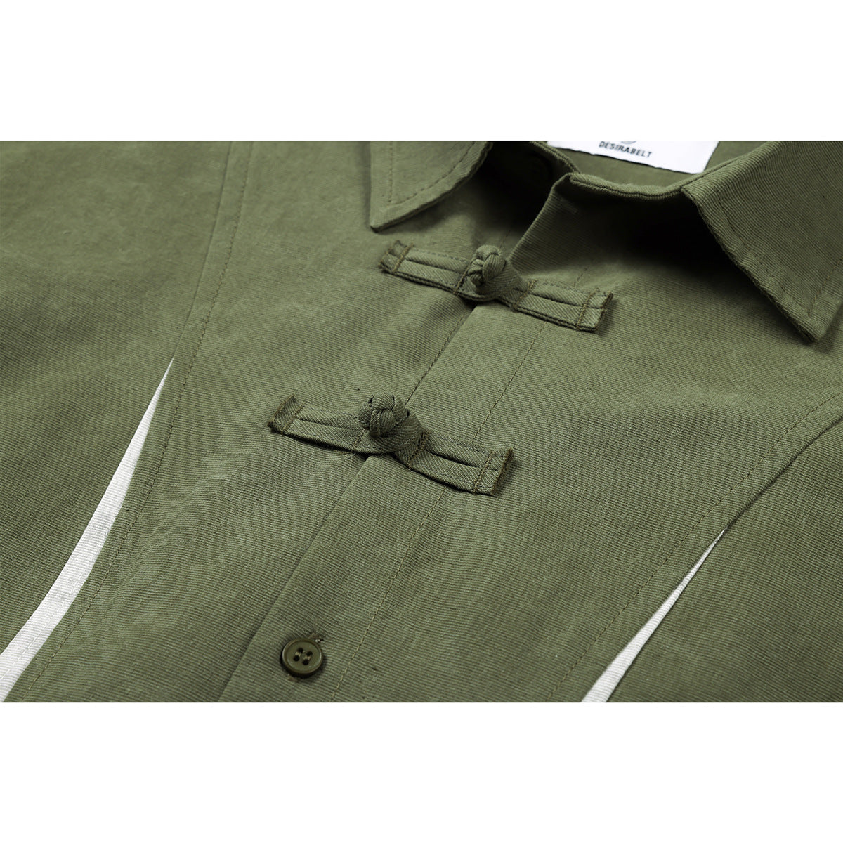 Close-up of an olive-green shirt collar and front with two knotted frog closures and a button.