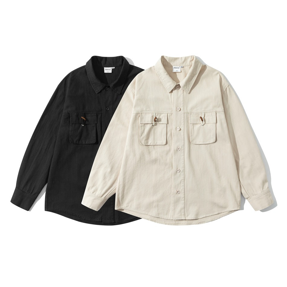 Two long-sleeve button-front shirts shown together: one black and one cream, each with two chest pockets.