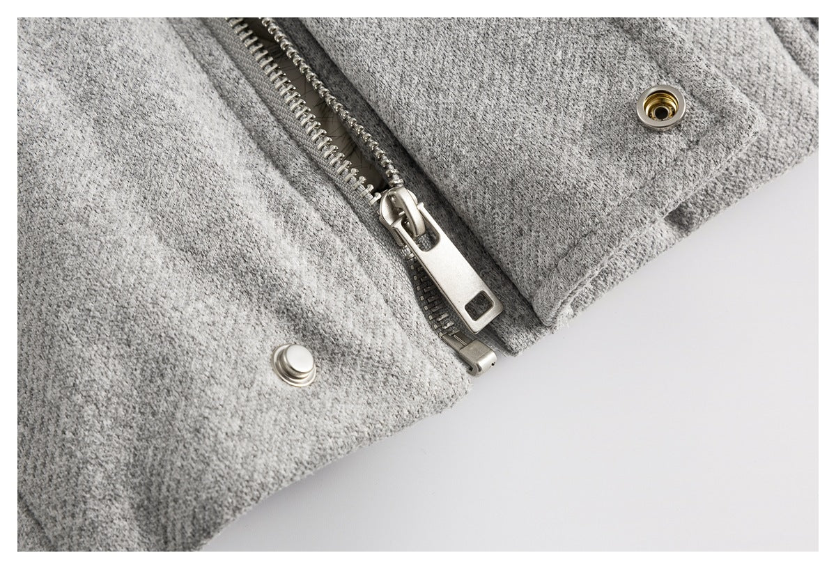 Close-up of the gray coat's metal zipper and snap fasteners.