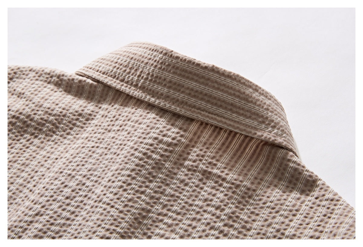 Close-up of the back collar and yoke of a beige-brown patterned shirt.