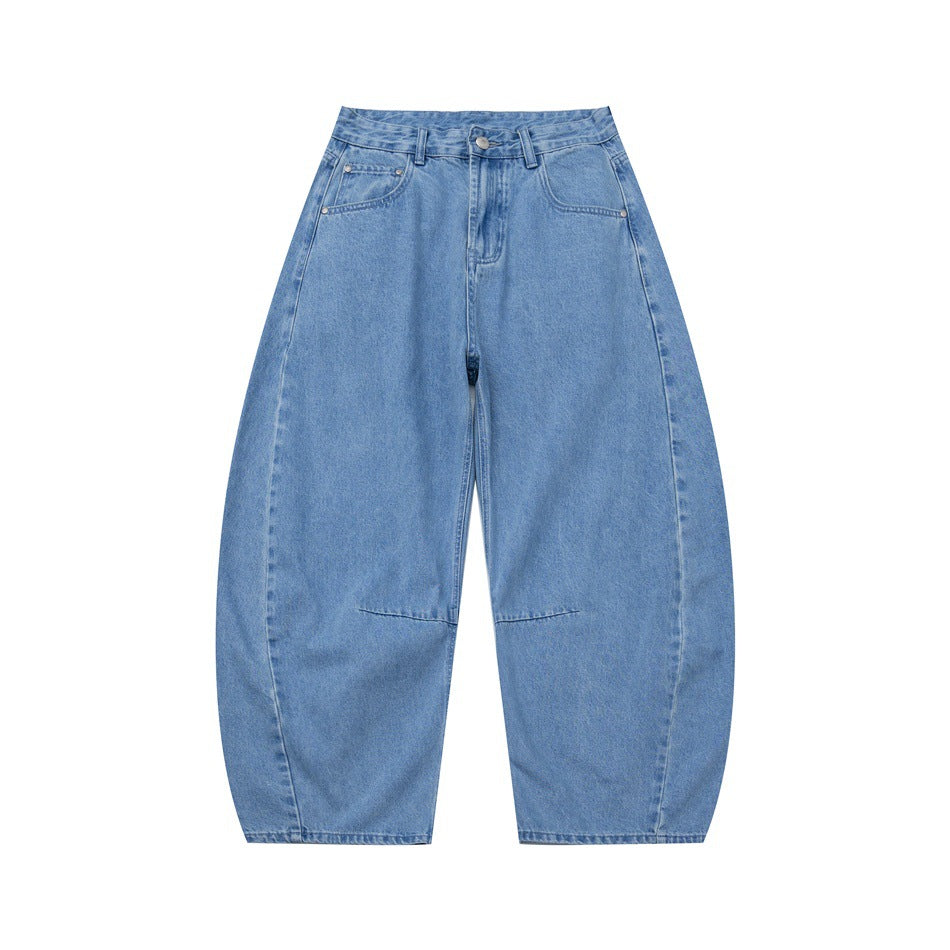 Light blue washed denim barrel-leg jeans, front view, with button fly, front pockets and curved knee seams