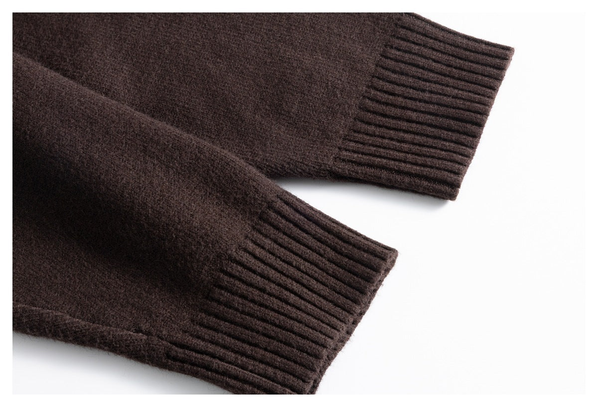 Close-up of two ribbed cuffs on a dark brown knit garment.
