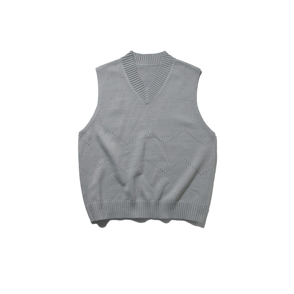 Gray knit V-neck sweater vest flat lay with ribbed trim and zigzag eyelet detail